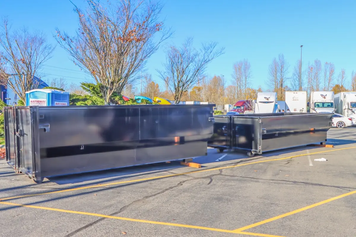Professional dumpster rental service with roll-off container on residential driveway in Hardyston